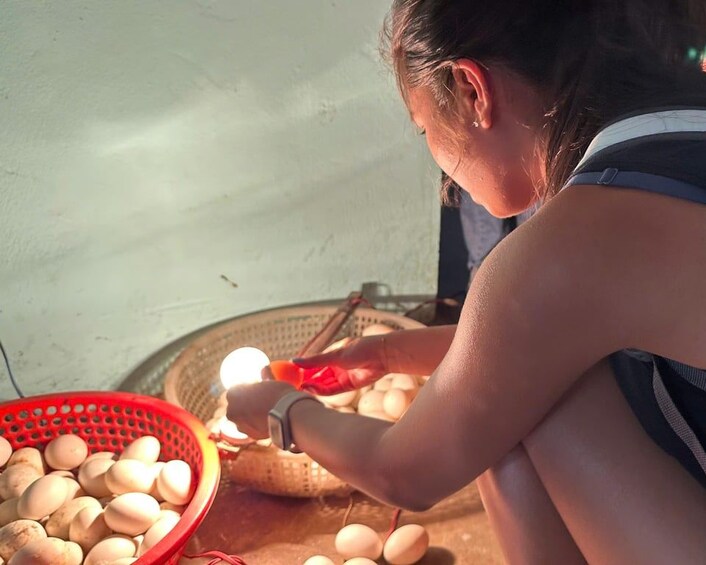 A person peeling eggs in a basket. 3