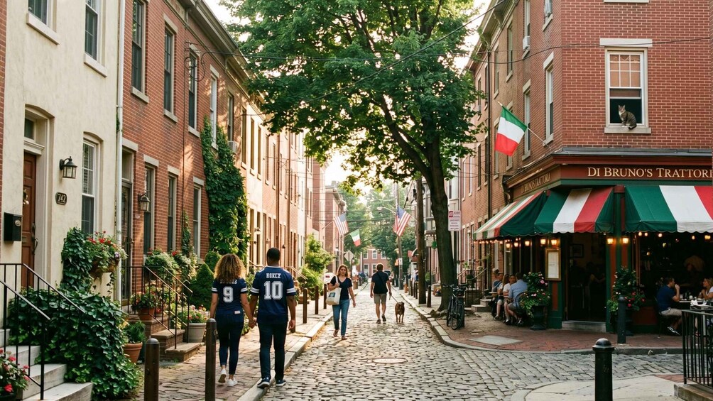 A cobblestone street lined with brick buildings, a couple walking, and a restaurant with an Italian flag. 2