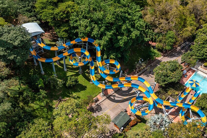 A water park with a winding water slide and a pool. 1