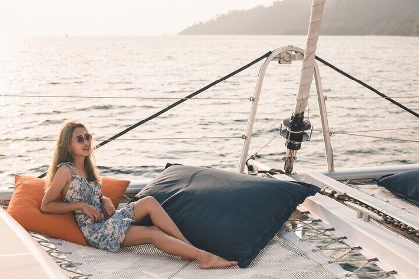 A person sitting on a boat with a view of the water and a distant shoreline. 2