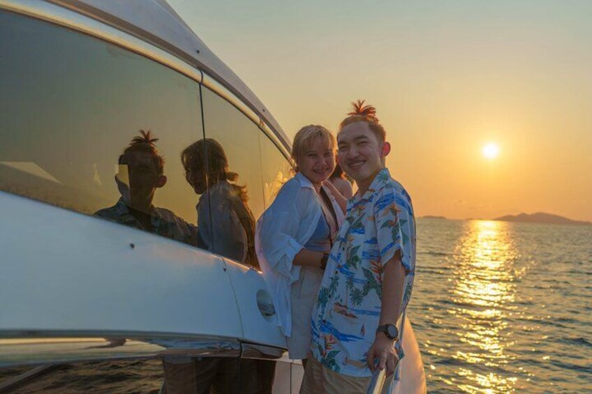 A sunset over water with a boat and people on board. 4
