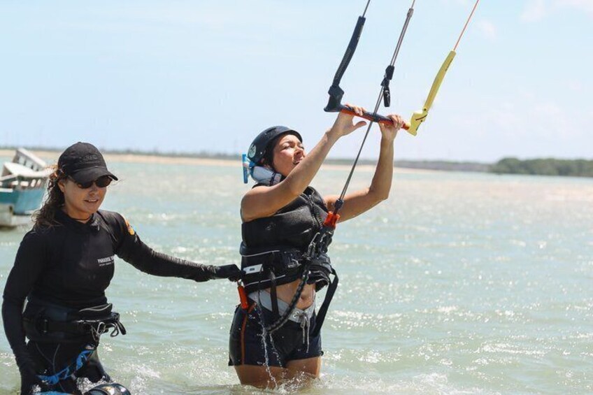 Two people in water with a parasail. 5