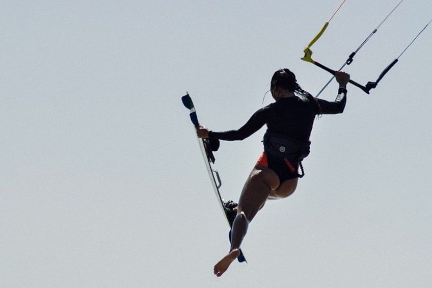 A person kiteboarding in the air. 1