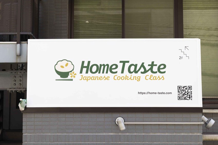 A signboard for 'HomeTaste Japanese Cooking Class' with a QR code and a URL. 5