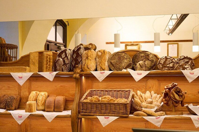 A bakery display with various breads and pastries. 4