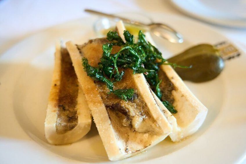 A dish with sliced meat and greens on a white plate. 1