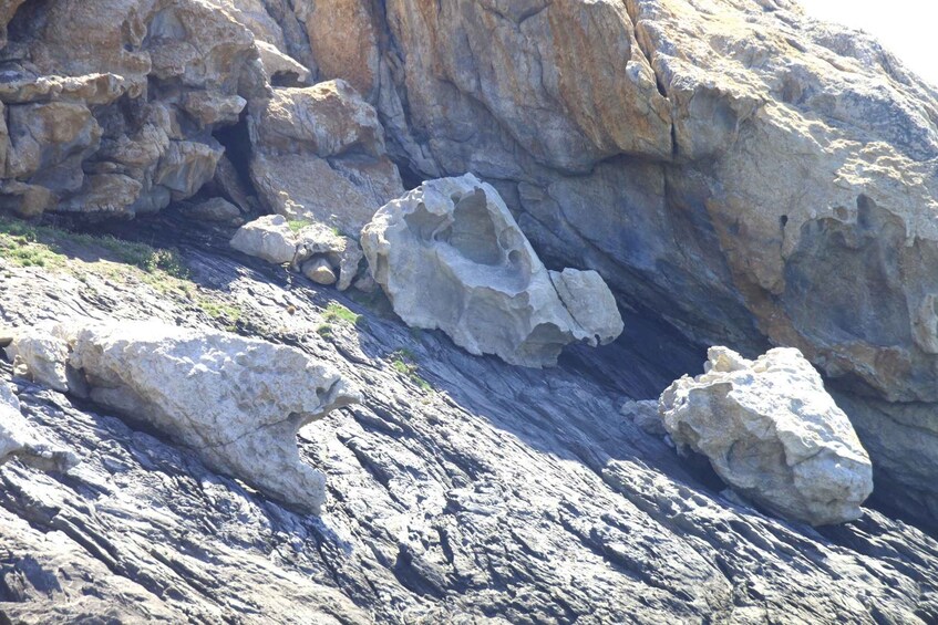 A rocky landscape with large boulders and a narrow crevice. 3
