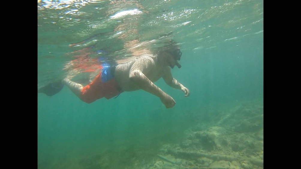 A person swimming underwater. 5