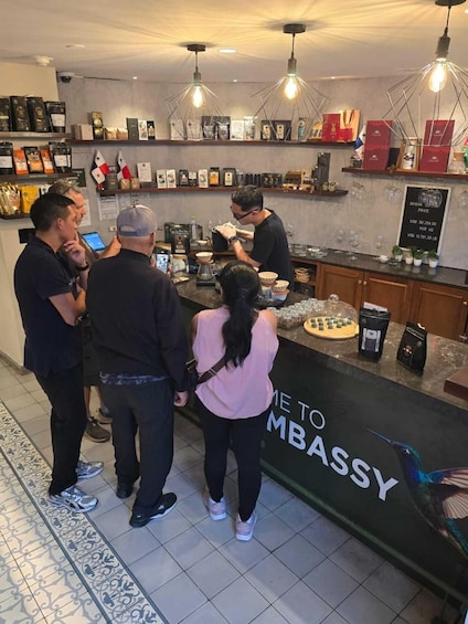 A coffee shop interior with a barista preparing drinks, a menu board, and a counter displaying coffee products. 1