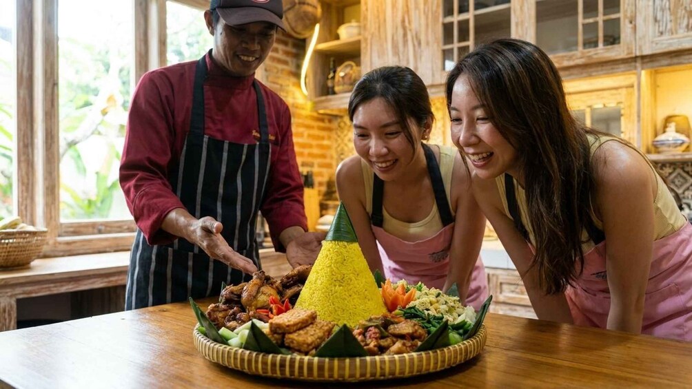 A meal with grilled chicken, yellow rice, and vegetables on a wooden table in a rustic kitchen. 4