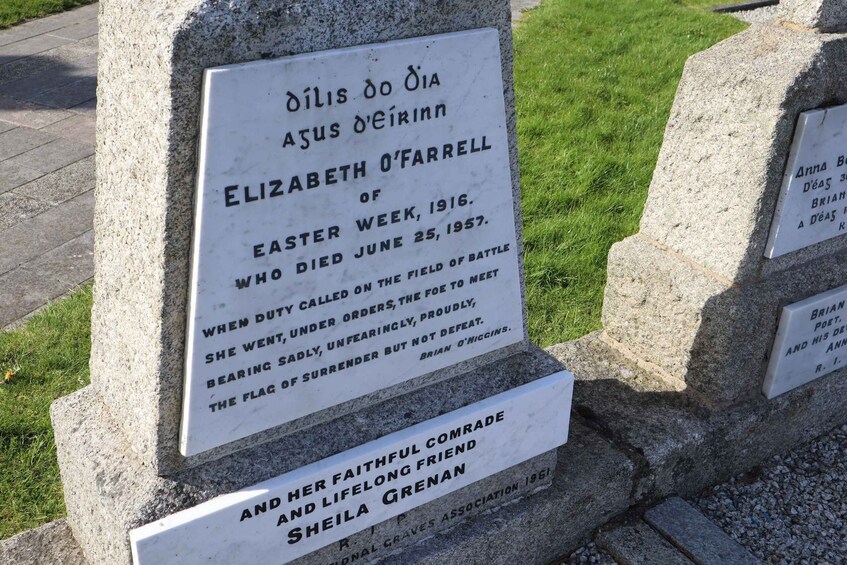 A memorial stone with inscriptions, including names and dates. 5