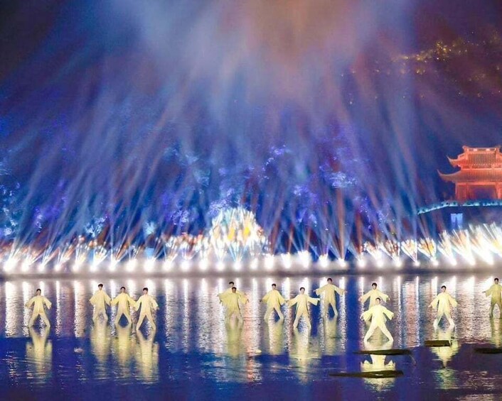 A water fountain show with performers in white costumes. 1
