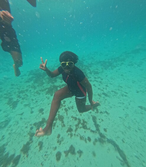 A person snorkeling underwater. 3
