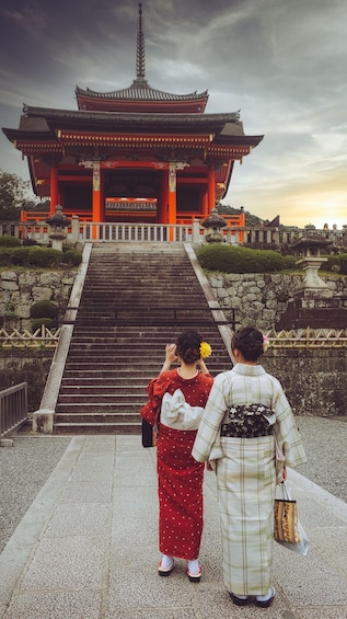 A traditional Japanese temple with a red gate, stone steps, and a stone lantern. 3