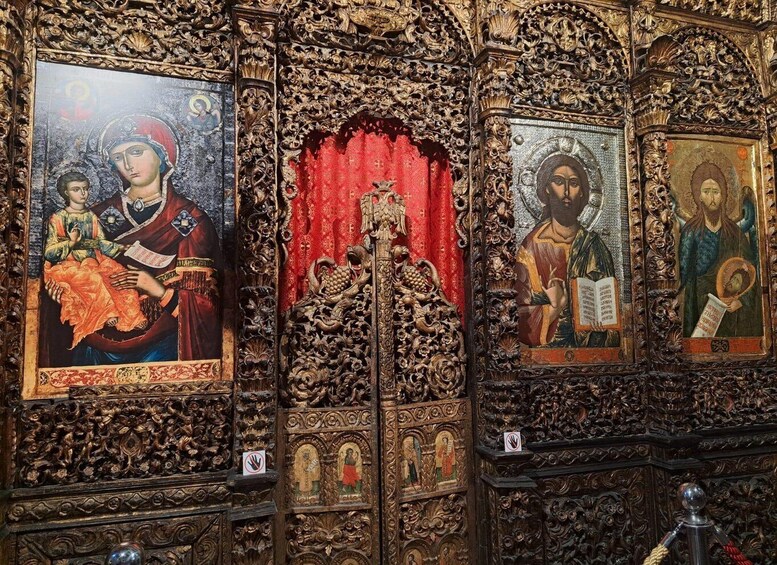 An ornate religious iconostasis with intricate carvings and religious paintings. 5
