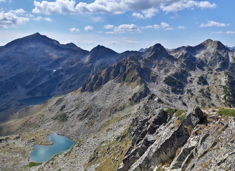 A mountainous landscape with rocky terrain and a small lake. 4