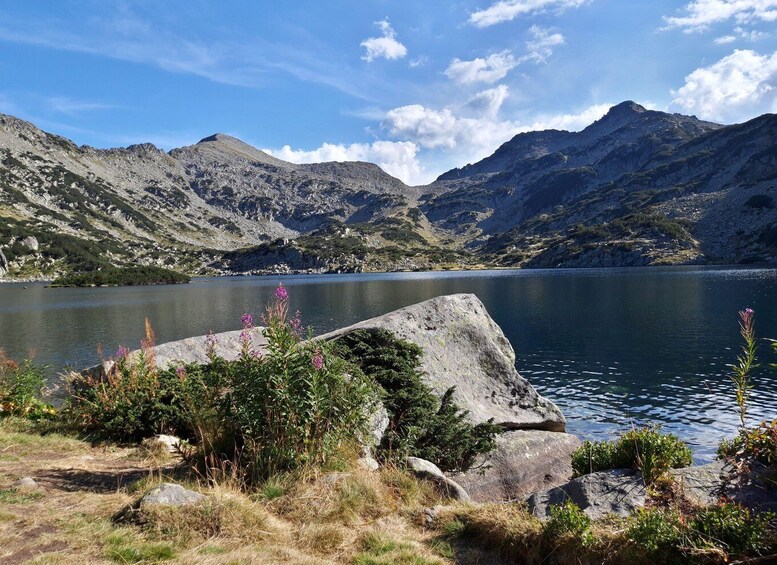 A mountain lake with rocky shores and sparse vegetation. 5