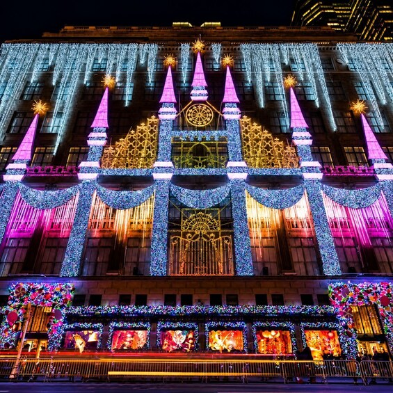A building adorned with festive lights and decorations, including illuminated trees and a large display of colorful lights. 5