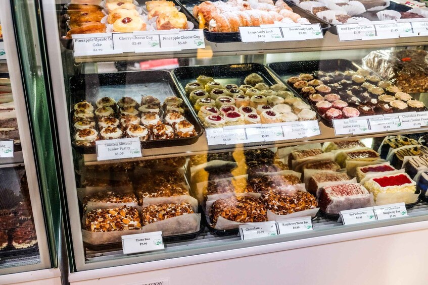 A bakery display case with various pastries and desserts. 2