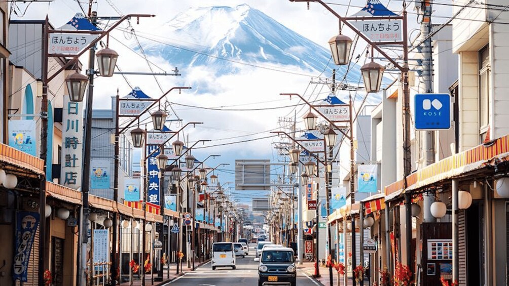 A street lined with shops and a mountain in the background. 1