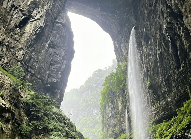 A waterfall cascading through a natural rock arch. 5