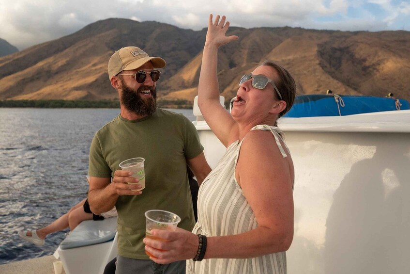 Two people on a boat with a mountainous landscape in the background. 4