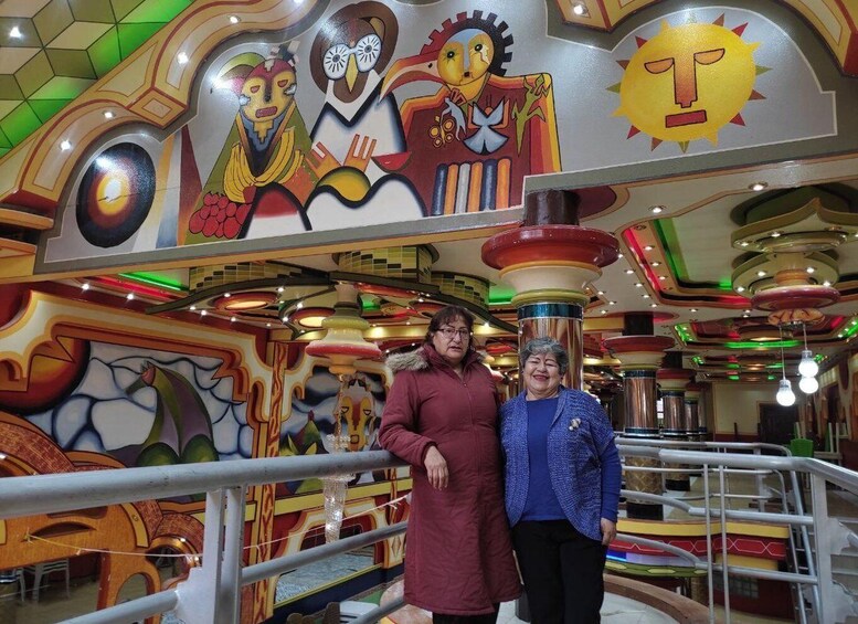 A colorful interior with abstract murals and a modern ceiling design. 3