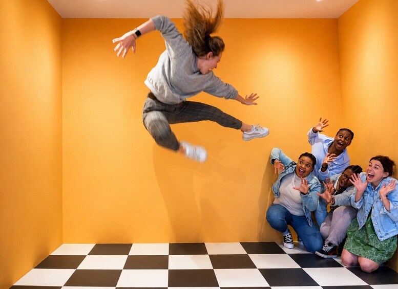 A person jumping in the air with a group of people on the floor. 1