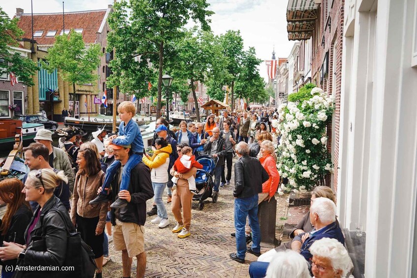 A crowded street with people, a boat, and buildings. 2