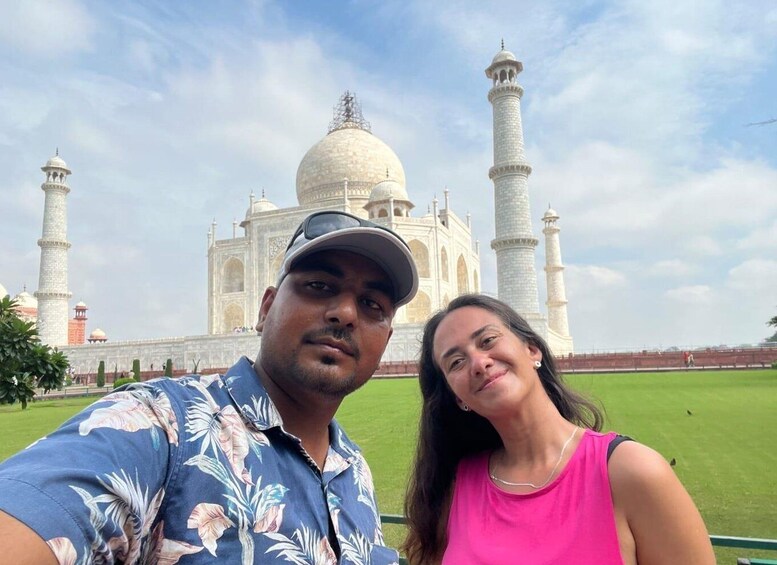 A couple taking a selfie with the Taj Mahal in the background. 4