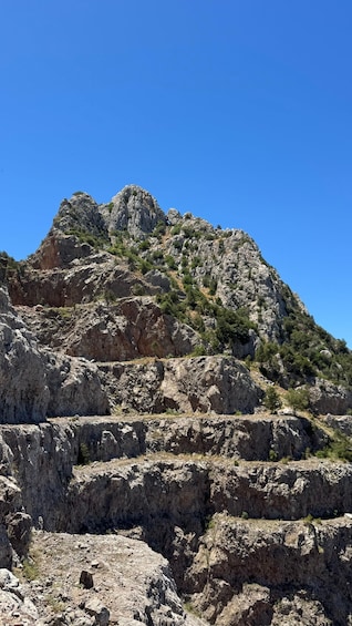 A rugged mountain with rocky terrain and sparse vegetation. 5