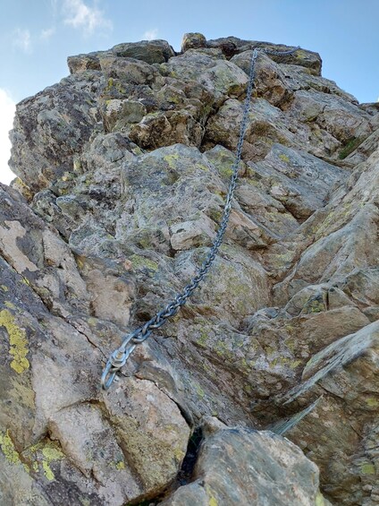 A rocky mountain peak with a metal chain. 3