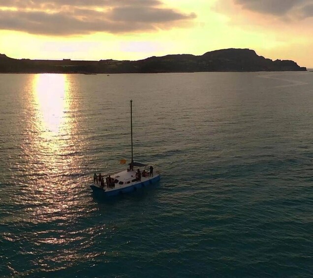 A boat on calm water with a sunset in the background. 5