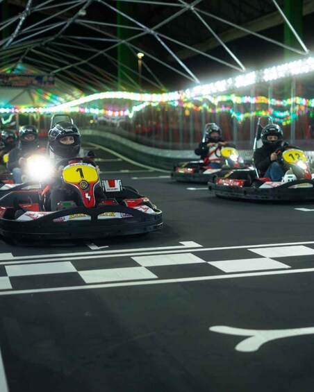 Go-karts racing on a track with numbered signs. 2