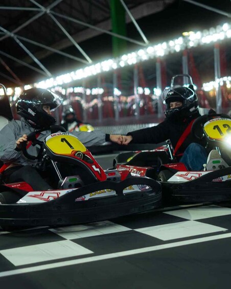 Go-karts with racing numbers on a track. 3