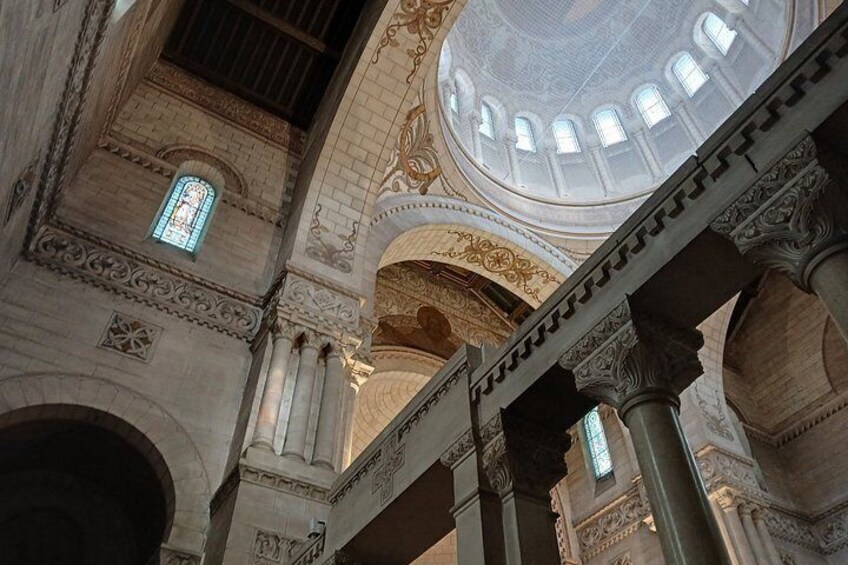 An ornate interior with columns, arches, and a dome. 5