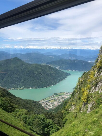 A mountainous landscape with a lake and a town. 4