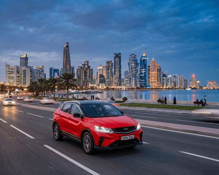 A red car driving on a city street with a skyline in the background. 5