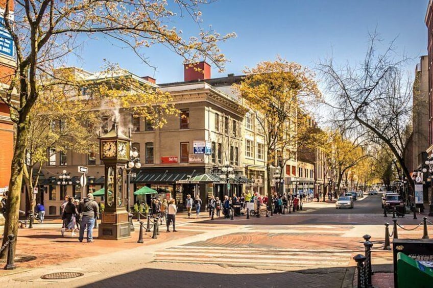 A bustling city street with pedestrians, historic buildings, and a prominent clock tower. 1