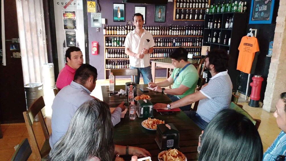 A group of people dining at a restaurant with a bartender standing behind the counter. 4