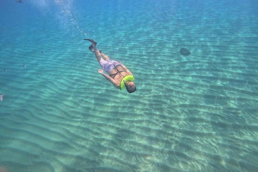 A person snorkeling underwater. 5