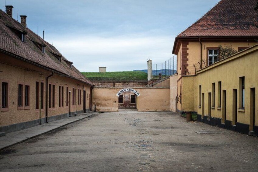 A courtyard with buildings, a sign reading 'ABBEY HOUSE,' and a hill in the background. 5