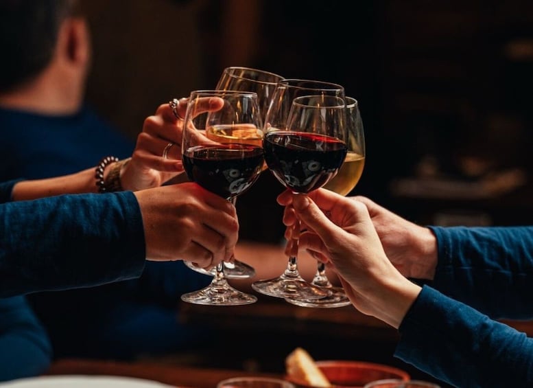 A group of people clinking glasses of wine. 3