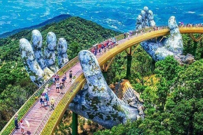 A bridge with a unique rock formation design, surrounded by lush greenery and a mountainous landscape. 4