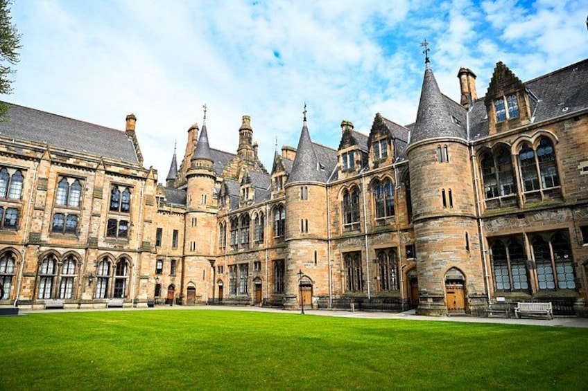 A historic building with multiple towers and a large courtyard. 4