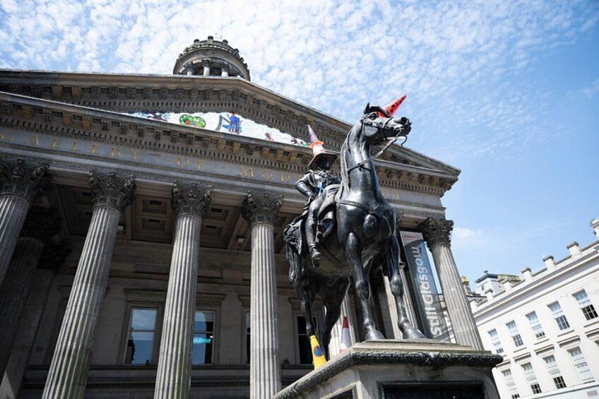 A classical building with columns and a statue of a horse. 2