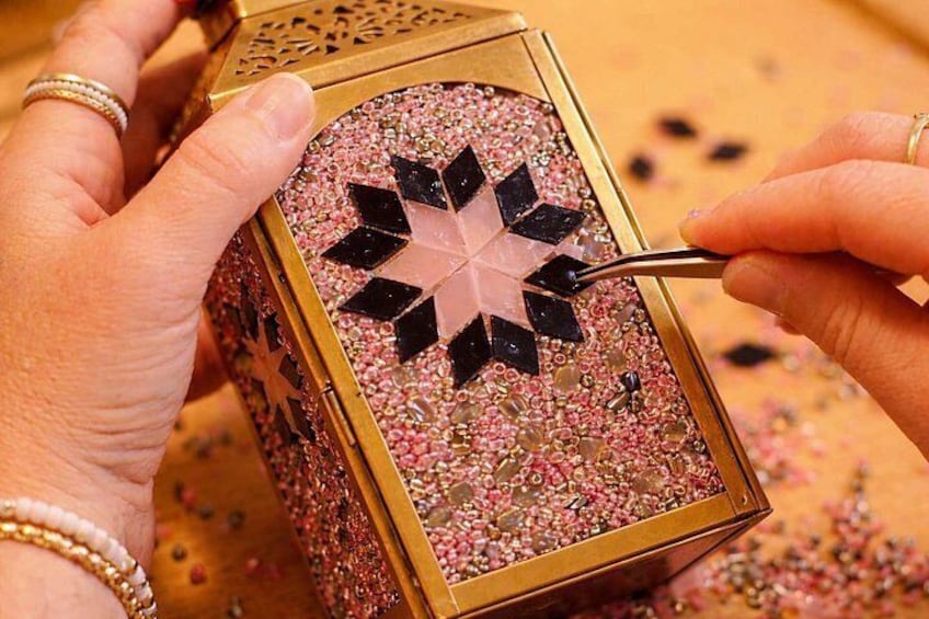 A person crafting a decorative box with a star pattern. 3