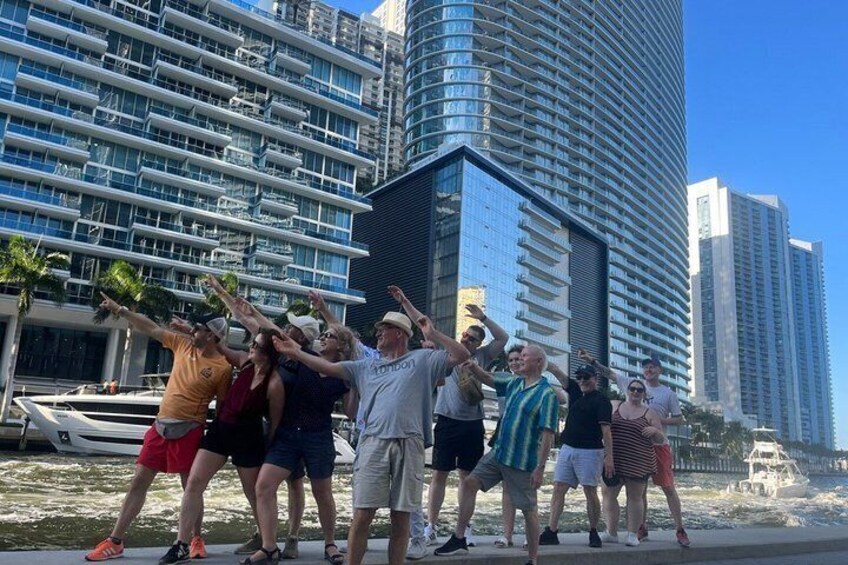 A group of people dancing on a beach with high-rise buildings in the background. 5