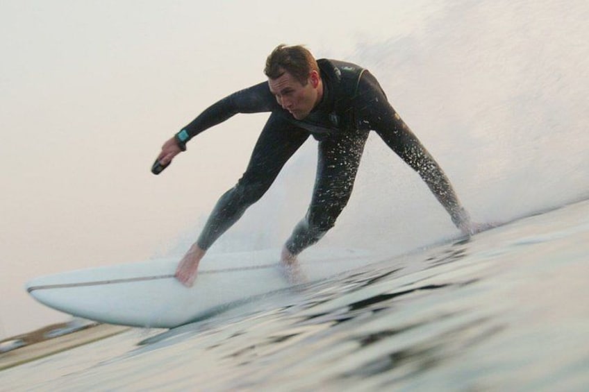 A person surfing on a wave. 3