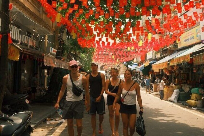 A street with shops and hanging decorations. 3